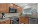 A modern kitchen showcases stainless steel appliances, granite countertops, and updated cabinetry for a sleek look at 4234 Gulf Of Mexico Dr # E2, Longboat Key, FL 34228
