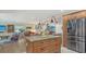 Open-concept kitchen with a granite island, stainless appliances, and a view of the dining and living areas at 4234 Gulf Of Mexico Dr # E2, Longboat Key, FL 34228