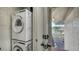 Laundry area with stacked washer and dryer next to the entry way to a pool at 4234 Gulf Of Mexico Dr # E2, Longboat Key, FL 34228