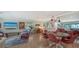Bright living room with water view, stylish furniture and access to outdoor balcony at 4234 Gulf Of Mexico Dr # E2, Longboat Key, FL 34228