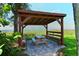 Shaded community picnic area with ocean views, picnic table, and benches surrounded by lush landscaping at 4234 Gulf Of Mexico Dr # E2, Longboat Key, FL 34228
