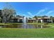 Scenic view of pond with fountain surrounded by lush landscaping and tropical plants at 4234 Gulf Of Mexico Dr # E2, Longboat Key, FL 34228