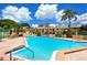 Beautiful community pool with crystal clear water and plenty of lounge chairs, surrounded by mature landscaping at 4234 Gulf Of Mexico Dr # E2, Longboat Key, FL 34228