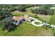 Expansive property featuring a pool, circular driveway, and an outbuilding nestled on a lush, green lawn at 5750 Saddle Oak Trl, Sarasota, FL 34241