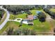 The property features a circular driveway, manicured lawn, pool, white fence, and two ponds at 5750 Saddle Oak Trl, Sarasota, FL 34241
