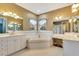 This bathroom boasts a tub, and vanities, and windows at 5750 Saddle Oak Trl, Sarasota, FL 34241