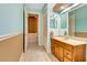 Well-lit bathroom with wood vanity and a large mirror, offering ample space and functionality at 5750 Saddle Oak Trl, Sarasota, FL 34241