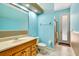 Bright bathroom features a wood vanity, neutral countertops, and a walk-in shower with a glass door at 5750 Saddle Oak Trl, Sarasota, FL 34241