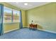 A cozy bedroom with a ceiling fan, window, and comfortable blue carpeting at 5750 Saddle Oak Trl, Sarasota, FL 34241