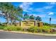 Community entrance sign at Saddle Oak Estates is surrounded by mature trees and landscaping at 5750 Saddle Oak Trl, Sarasota, FL 34241