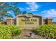 A stone monument sign for Saddle Oak Estates with lush landscaping at 5750 Saddle Oak Trl, Sarasota, FL 34241