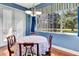 Inviting dining area with wood floors, a round table, and a view of the screened-in lanai at 5750 Saddle Oak Trl, Sarasota, FL 34241