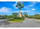 View of the community's entrance with manicured landscaping and a decorative guard house at 5750 Saddle Oak Trl, Sarasota, FL 34241