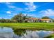Beautiful home with a screened-in pool, a charming pond, and lush greenery at 5750 Saddle Oak Trl, Sarasota, FL 34241