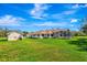 Beautiful home exterior with a large yard, detached garage, and screened-in pool enclosure at 5750 Saddle Oak Trl, Sarasota, FL 34241