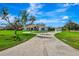 Long driveway leading to this home's front entrance and detached garage at 5750 Saddle Oak Trl, Sarasota, FL 34241