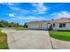 Home featuring a spacious 2 car garage, ample driveway, and landscaping at 5750 Saddle Oak Trl, Sarasota, FL 34241