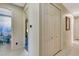 Hallway featuring tile flooring, a closet, and views into the bathroom and bedroom at 5750 Saddle Oak Trl, Sarasota, FL 34241