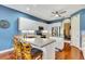 Bright kitchen featuring white cabinets, stainless steel appliances, and a breakfast bar at 5750 Saddle Oak Trl, Sarasota, FL 34241