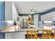 Open kitchen boasts white cabinets, stainless steel appliances, and a spacious countertop with bar seating at 5750 Saddle Oak Trl, Sarasota, FL 34241