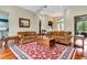 Elegant living room showcasing hardwood floors, a rug, and sofas at 5750 Saddle Oak Trl, Sarasota, FL 34241