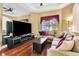Cozy living room featuring a large TV and comfortable seating at 5750 Saddle Oak Trl, Sarasota, FL 34241