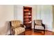 This is a sitting area of a room with wood floors and a bookshelf at 5750 Saddle Oak Trl, Sarasota, FL 34241