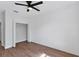 Bedroom featuring wood-look floors, shiplap accent wall, and an open closet at 6832 Bay Hill Dr, Lakewood Ranch, FL 34202