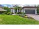 Beautiful home with a tile roof, manicured lawn, and a two-car garage, showcasing great curb appeal at 6832 Bay Hill Dr, Lakewood Ranch, FL 34202