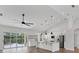 Modern kitchen with white cabinets, stainless steel appliances, an island with pendant lighting, and views of the pool at 6832 Bay Hill Dr, Lakewood Ranch, FL 34202
