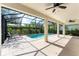 Spacious covered patio with ceiling fans and lounge chairs overlooking pool at 6832 Bay Hill Dr, Lakewood Ranch, FL 34202