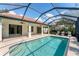 Screened-in pool with tile border and covered patio at 6832 Bay Hill Dr, Lakewood Ranch, FL 34202