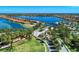 Breathtaking aerial view of a lakefront community featuring stunning homes, lush landscaping and mature trees at 701 Maraviya Blvd, Nokomis, FL 34275