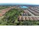 Expansive aerial view showcasing a well-developed community with beautiful homes and a scenic lake at 701 Maraviya Blvd, Nokomis, FL 34275