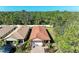 Stunning aerial view showing the home, its tile roof, brick driveway, and the surrounding neighborhood at 701 Maraviya Blvd, Nokomis, FL 34275