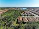 Aerial view of a residential community featuring a lake and lush green spaces at 701 Maraviya Blvd, Nokomis, FL 34275