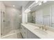 Bathroom featuring dual sink vanity, granite countertop, modern fixtures, and a glass shower at 701 Maraviya Blvd, Nokomis, FL 34275