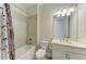 Bathroom featuring a bathtub with shower, toilet, vanity with granite countertop, and tile surround at 701 Maraviya Blvd, Nokomis, FL 34275