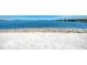 White sandy beach area with water view, providing a tranquil escape for community residents at 701 Maraviya Blvd, Nokomis, FL 34275