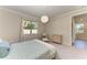 Bright bedroom with plush carpet, modern lighting, window views, and calming neutral color palette at 701 Maraviya Blvd, Nokomis, FL 34275