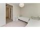Bedroom featuring two twin beds with white bedding and a modern light fixture at 701 Maraviya Blvd, Nokomis, FL 34275
