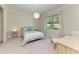 Well-lit bedroom with neutral tones, featuring a comfortable bed and a large window at 701 Maraviya Blvd, Nokomis, FL 34275