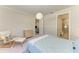 Bright bedroom with a comfortable chair and a large bed with a bedside table at 701 Maraviya Blvd, Nokomis, FL 34275