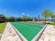 Enjoy the bocce ball court and playground surrounded by lush greenery on sunny days in this community at 701 Maraviya Blvd, Nokomis, FL 34275