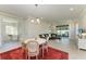 Stylish dining area with a round table, chandelier, and views of the living room and outdoor patio at 701 Maraviya Blvd, Nokomis, FL 34275