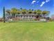 A lush green lawn and beautiful flowers surround the community entrance sign in this gorgeous neighborhood at 701 Maraviya Blvd, Nokomis, FL 34275