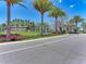 Beautiful community entrance featuring lush landscaping, mature palms, and a decorative sign at 701 Maraviya Blvd, Nokomis, FL 34275
