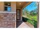 Close up of the attractive front entry featuring stone accents and a modern glass door at 701 Maraviya Blvd, Nokomis, FL 34275