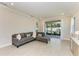 Bright living room with sliding glass doors leading to outdoor space, featuring a comfortable gray sectional at 701 Maraviya Blvd, Nokomis, FL 34275
