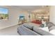 Open-concept living space with kitchen and dining area, featuring a gray sectional and tile floors at 701 Maraviya Blvd, Nokomis, FL 34275